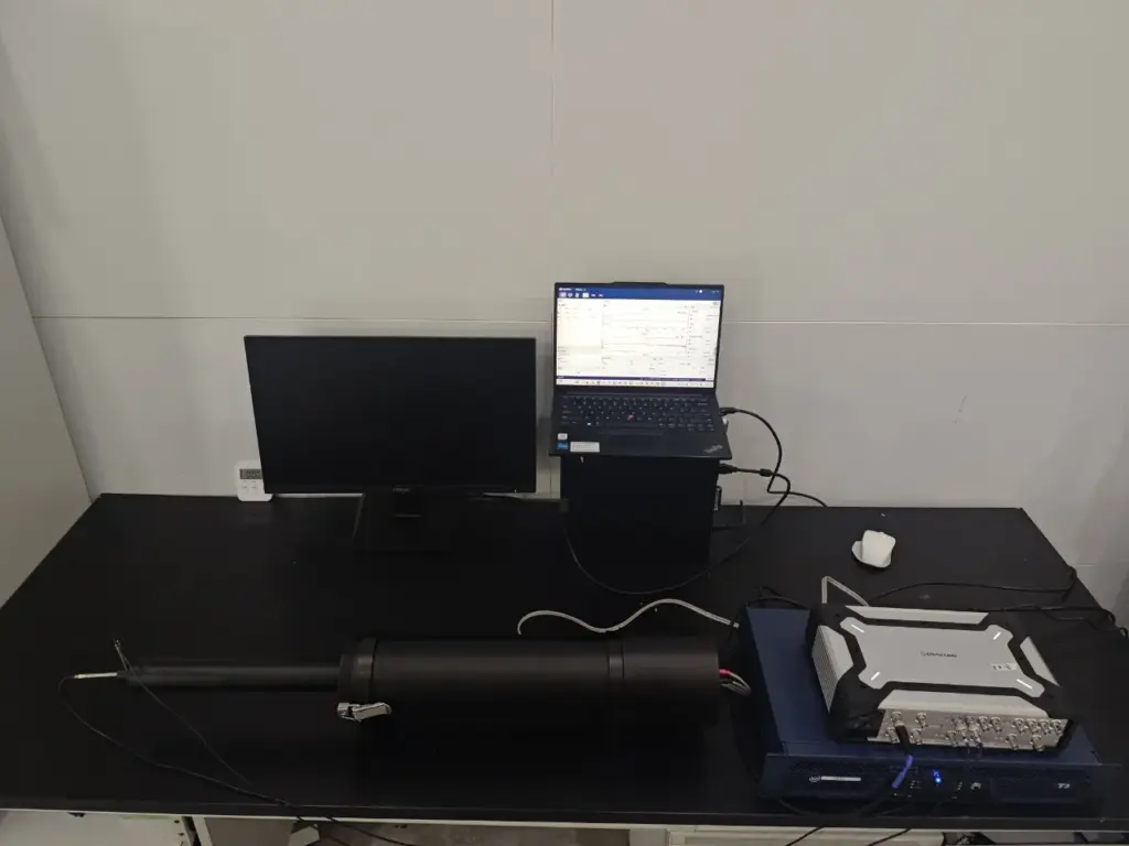 High SPL calibration and measurement system setup with reference microphone, sound source, and acoustic test instrumentation.